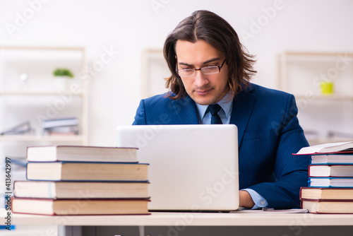 Young businessman student studying at workplace © Elnur