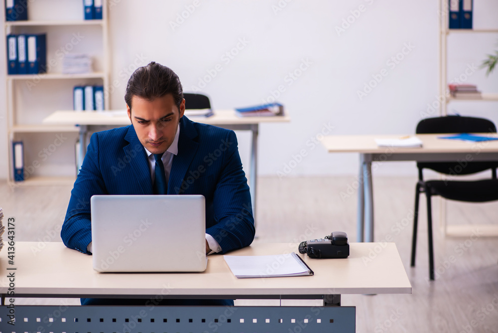 Young male employee working in the office