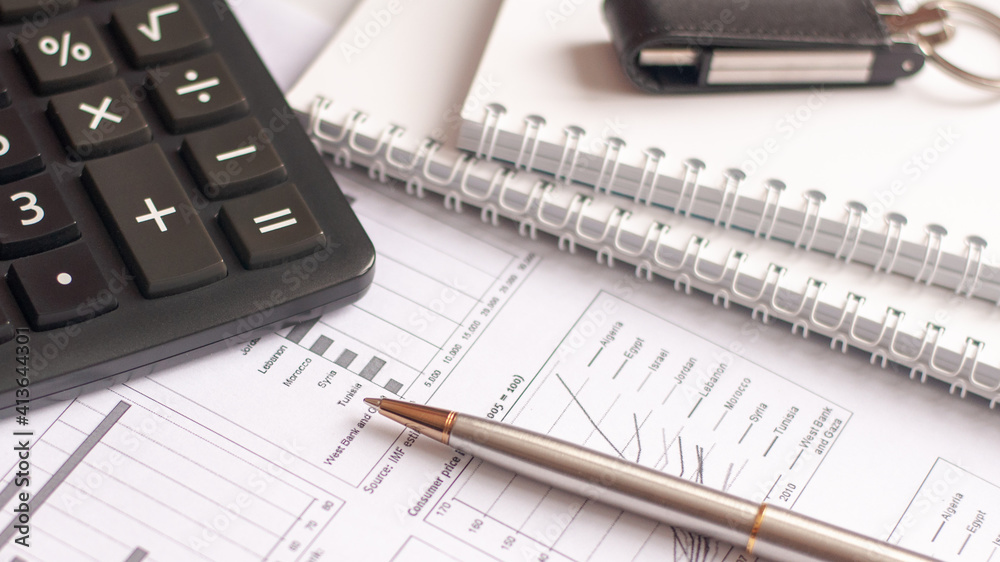 Paper, financial report, pen, notepad, flash drive on a white background Paper, financial report, pen, notepad, flash drive on a white background