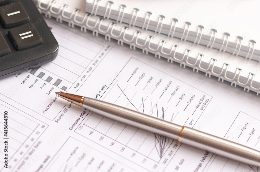 Paper, financial report, pen, notepad, flash drive on a white background Paper, financial report, pen, notepad, flash drive on a white background