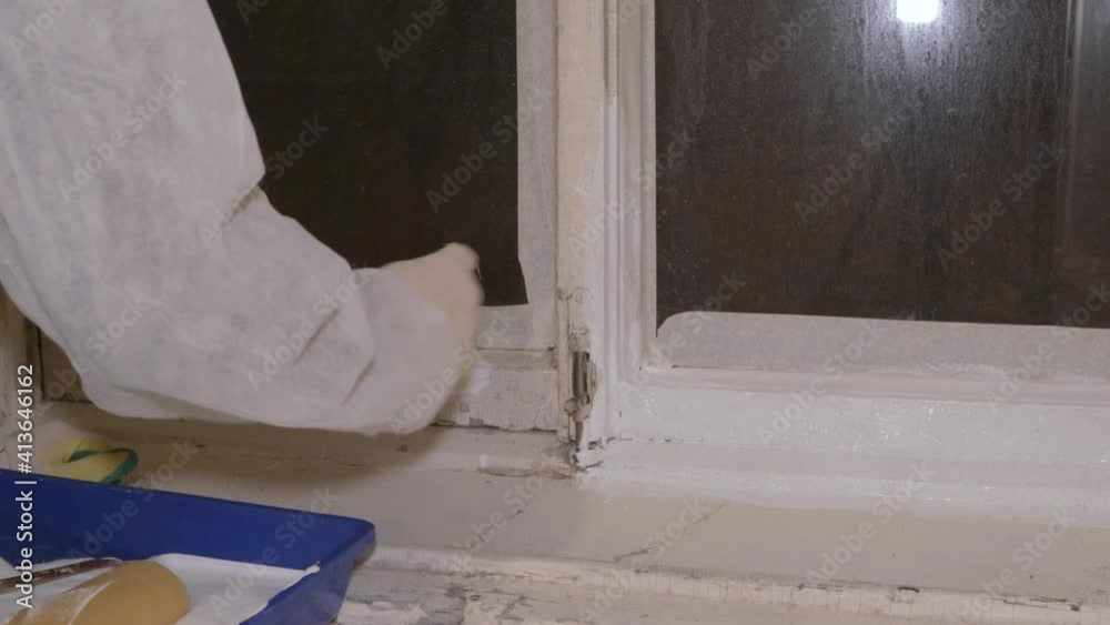 painter in protective suit respirator gloves paints windows brush painter in protective suit respirator gloves paints windows brush