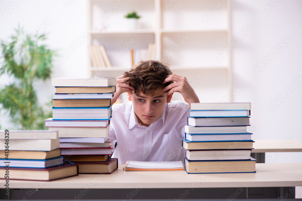 Schoolboy preparing for exams in the classroom Schoolboy preparing for exams in the classroom
