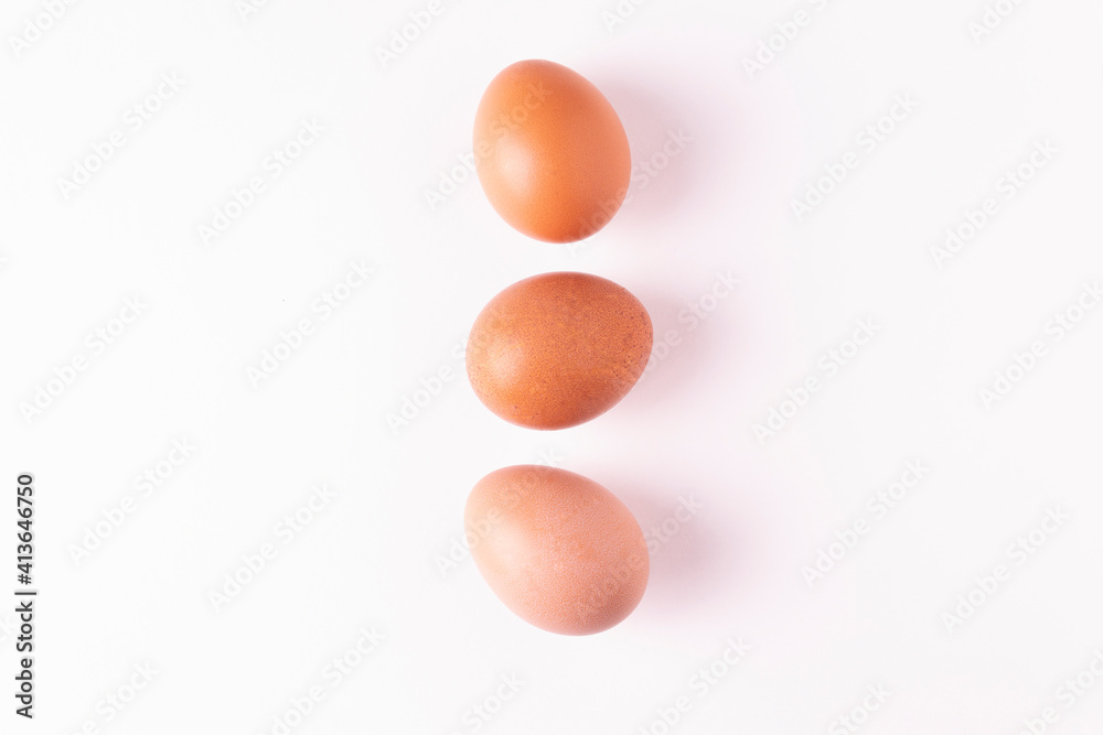 Isolated chicken eggs on a white background. Horizontal orientation. Top view.