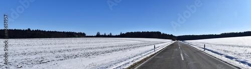 Way and road into the winter landscape cold season wonderful panorama. Cold season with snow and blue sky.