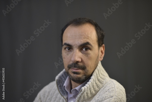 Spanish man with black hair and woolen clothes
