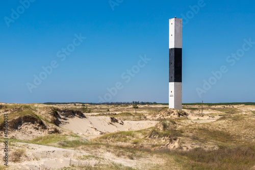 Lighthouse and dunes photo