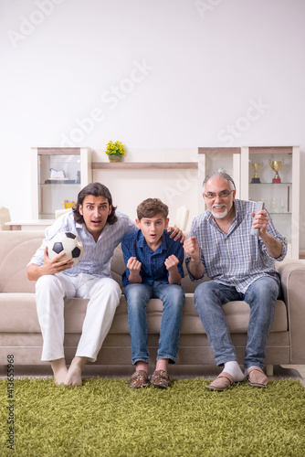 Boy and his father and his grandfother indoor