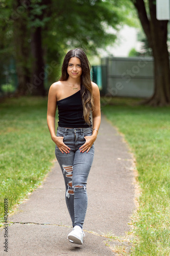 Portrait of beautiful young woman in the park street