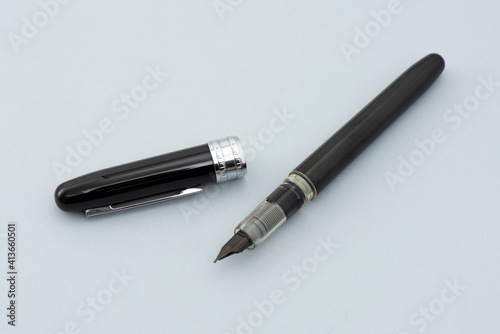 Black signature pen on the gray background.