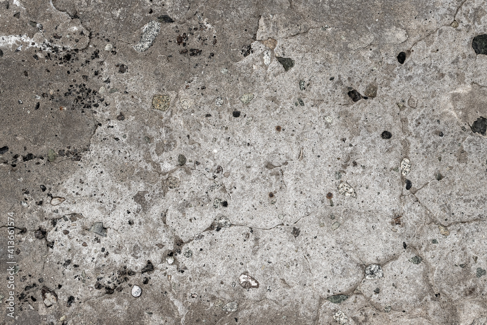 Texture of an old cracked concrete wall. Rough concrete surface with small pebbles. Great for background and design. Close-up. Texture of an old cracked concrete wall. Rough concrete surface with small pebbles. Great for background and design. Close-up.