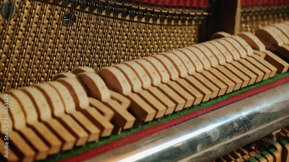 Beautiful playing the piano in the studio close-up general plan. hammers and piano keys play together in a piece. Beautiful playing the piano in the studio close-up general plan. hammers and piano keys play together in a piece.