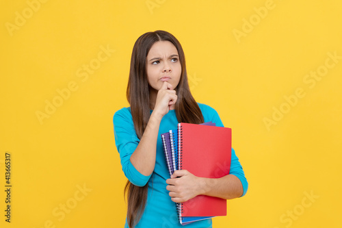 thoughtful child girl hold notepad for homework, school
