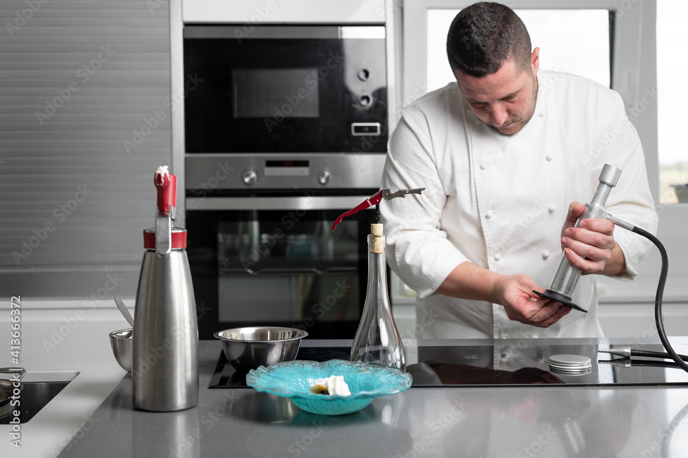 Fine dining restaurant chef preparing delicious plate with sophisticated utensils in commercial kitchen. High quality photo