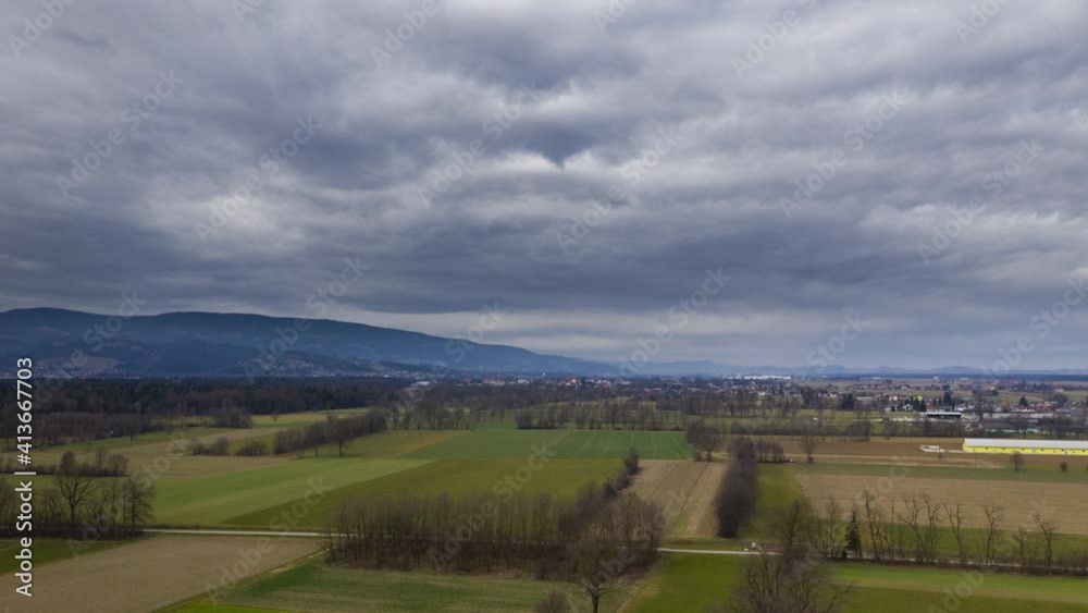 Aerial hyper lapse of rural landscape with hedges, meadows, and dramatic cloudscape, central European farming landscape, vicinity of Maribor, Slovenia Aerial hyper lapse of rural landscape with hedges, meadows, and dramatic cloudscape, central European farming landscape, vicinity of Maribor, Slovenia