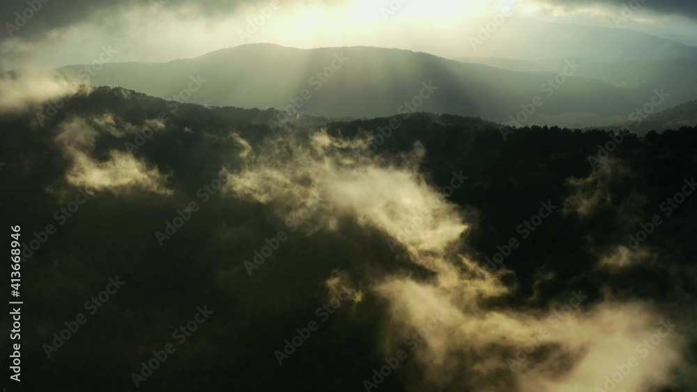 Drone flying above the mountains with clouds, in slow motion. Sunlight hits the mountains through the clouds. After rain.4K. Drone flying above the mountains with clouds, in slow motion. Sunlight hits the mountains through the clouds. After rain.4K.