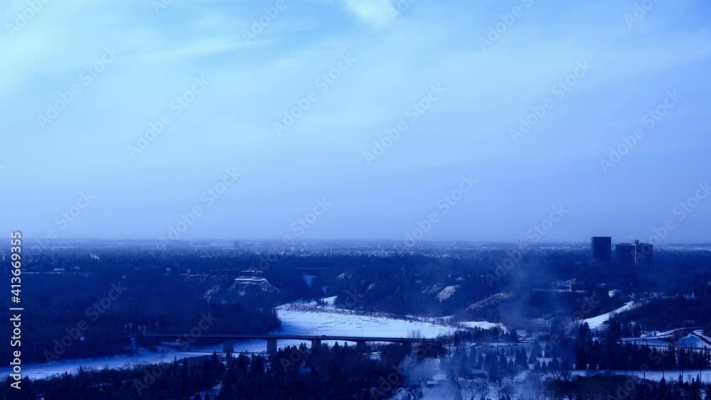 4k Time Lapse winter Groat Road NW Bridge over snow iced covered North Saskatchewan River clouds moving at forty five degrees siluotte cityscape skyline in blue gradations with lotsa steam clouds 4k Time Lapse winter Groat Road NW Bridge over snow iced covered North Saskatchewan River clouds moving at forty five degrees siluotte cityscape skyline in blue gradations with lotsa steam clouds