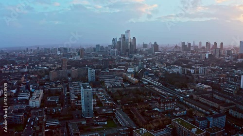 Parallax rotating aerial drone shot of City of London skyscrapers from Hackney at sunset photo