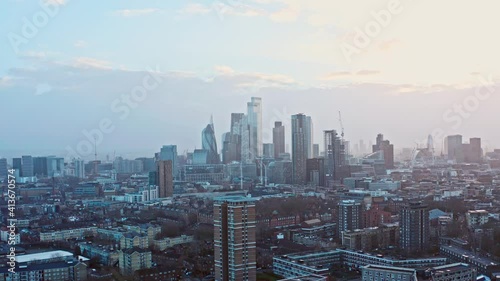 Rising aerial drone shot of city of London skyscrapers at sunset from the north photo