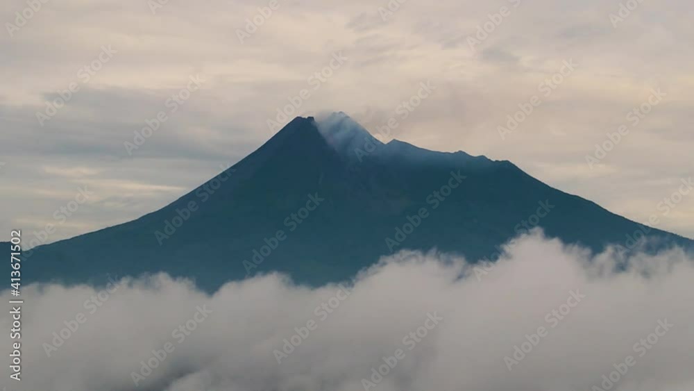 Aerial view above clouds on volcanic Mount Merapi on Java, Indonesia Aerial view above clouds on volcanic Mount Merapi on Java, Indonesia