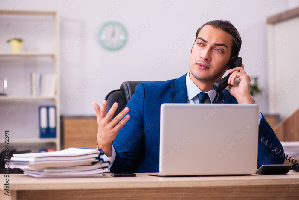 Young male employee working in the office Young male employee working in the office