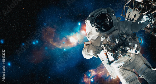 Astronaut spaceman do spacewalk while working for space station in outer space . Astronaut wear full spacesuit for space operation . Elements of this image furnished by NASA space astronaut photos. photo