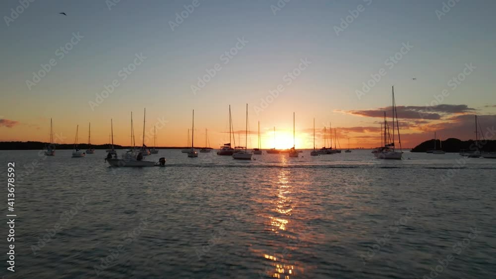 Aerial view over boats, anchored at the Biscayne bay, sunset, in Miami, Florida, USA - rising, drone shot Aerial view over boats, anchored at the Biscayne bay, sunset, in Miami, Florida, USA - rising, drone shot