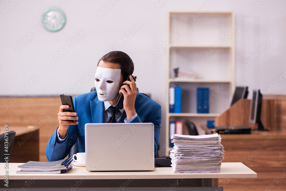 Young male employee wearing masks in the office Young male employee wearing masks in the office