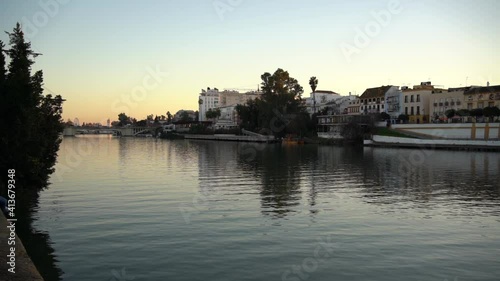 Twilight Above Guadaquivir River and Seville, Spain. Waterfront and Cityscape of Famous Spanish City photo