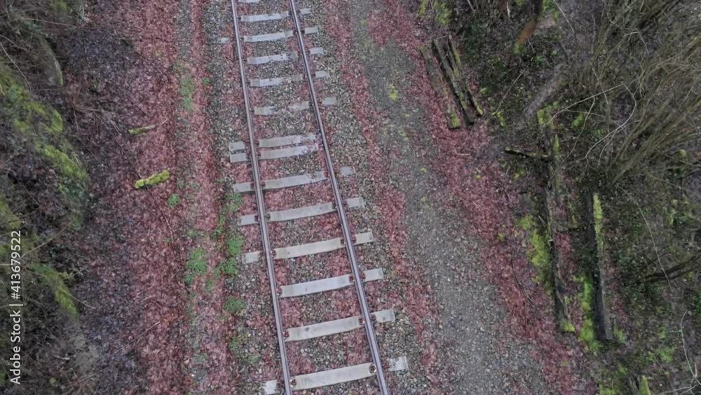 Railway Track With Fallen Leaves At Daytime. - aerial ascend Railway Track With Fallen Leaves At Daytime. - aerial ascend