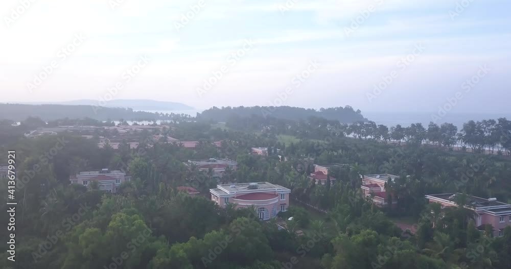 View Of The Lalit Golf And Spa Resort Near Rajbagh Beach, India With Different Buildings and Green Trees - Aerial Shot