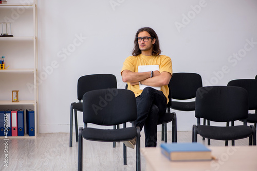 Young male student waiting for teacher in the classroom © Elnur