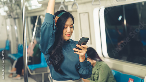 Obraz na płótnie Young woman mobile phone on public train