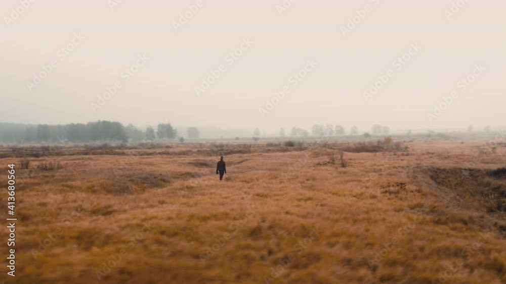 Photographer exploring and taking pictures in a misty autumn field. Photographer exploring and taking pictures in a misty autumn field.