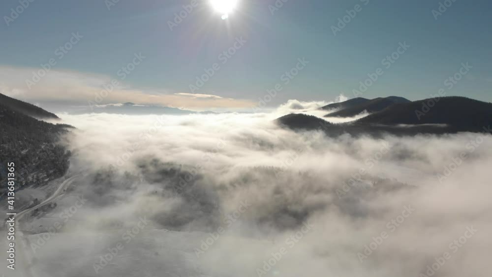 Dramatic aerial timelapse of fog rolling into quiet mountain valley Dramatic aerial timelapse of fog rolling into quiet mountain valley