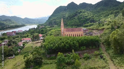 Wallpaper Mural A christian church in Vietnam next to a river surrounded by an epic landscape Torontodigital.ca