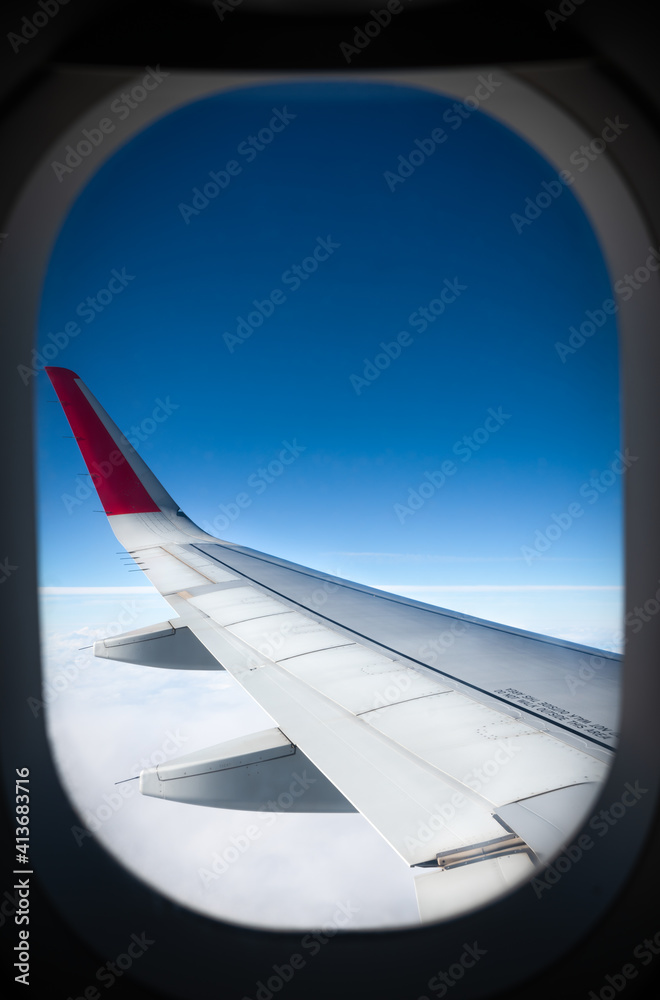 view of the blue sky and the wing of an airplane from the window view of the blue sky and the wing of an airplane from the window