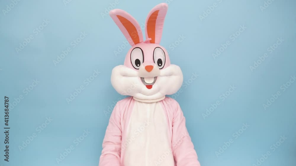 Positive funny man or kid singer or vocalist sings song to retro vintage classic microphone. Easter bunny or rabbit or hare celebrates Happy easter isolated on blue
