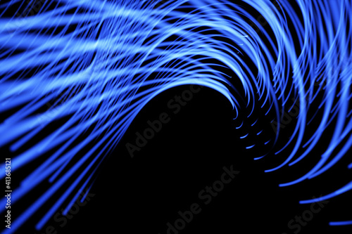 Abstract illustration of glowing blue digital wave against black background photo