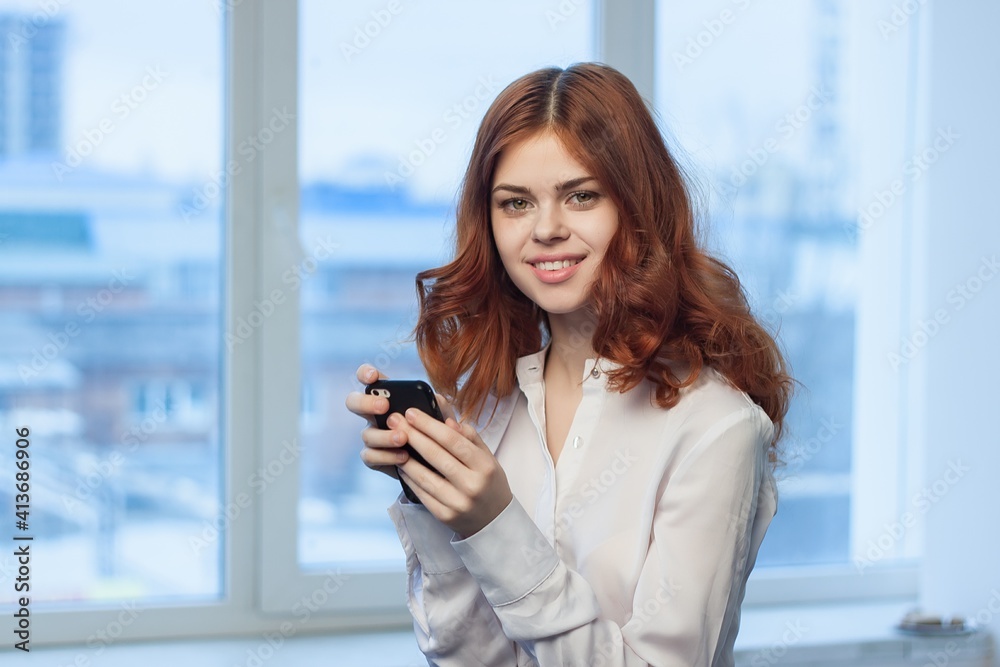 pretty woman in shirt with phone in hand communication Office professional pretty woman in shirt with phone in hand communication Office professional