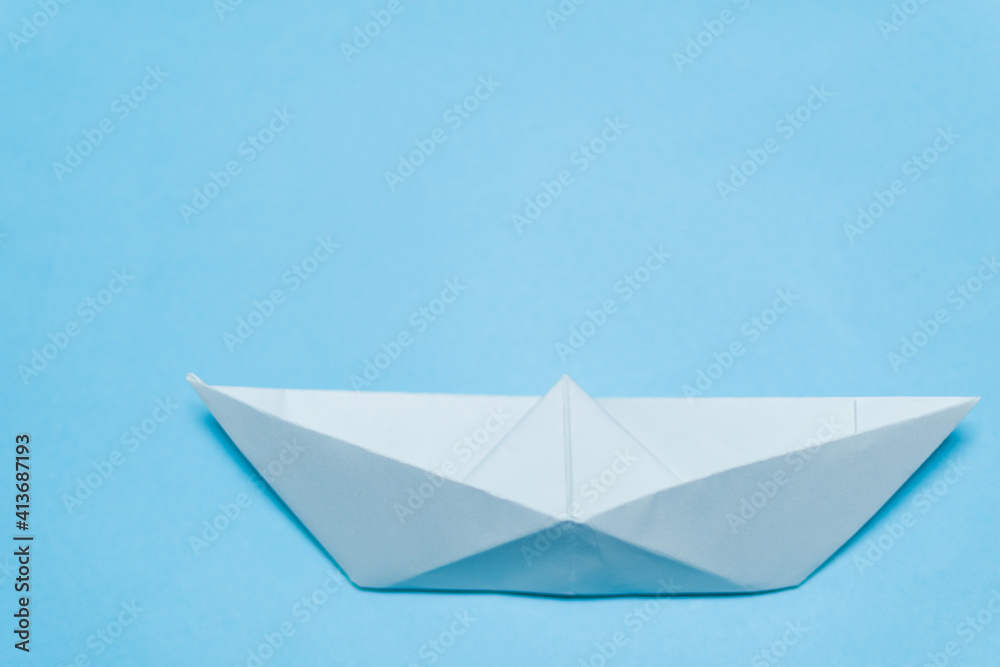 PAPER BOAT ON A BLUE BACKGROUND PAPER BOAT ON A BLUE BACKGROUND