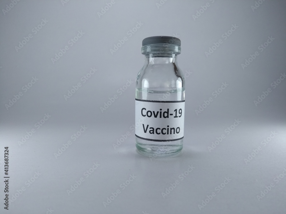The word Covid 19 vaccine written in Italian language on a bottle of vaccine The word Covid 19 vaccine written in Italian language on a bottle of vaccine