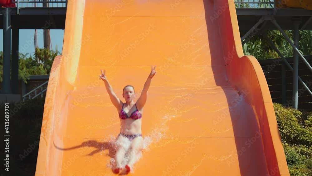 Young woman having fun on water slides