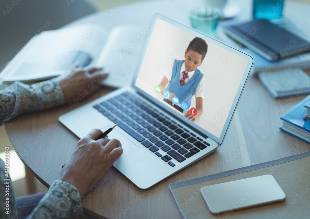 Caucasian schoolboy learning displayed on laptop screen during video call with female teacher Caucasian schoolboy learning displayed on laptop screen during video call with female teacher