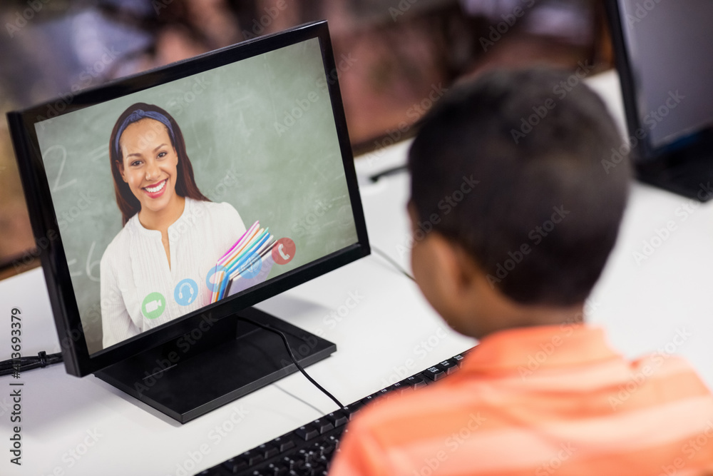 Mixed race schoolboy using computer on video call with female teacher Mixed race schoolboy using computer on video call with female teacher