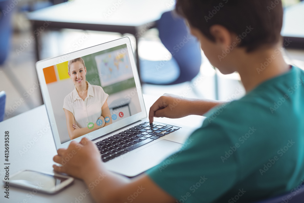 Caucasian schoolboy using laptop on video call with female teacher Caucasian schoolboy using laptop on video call with female teacher