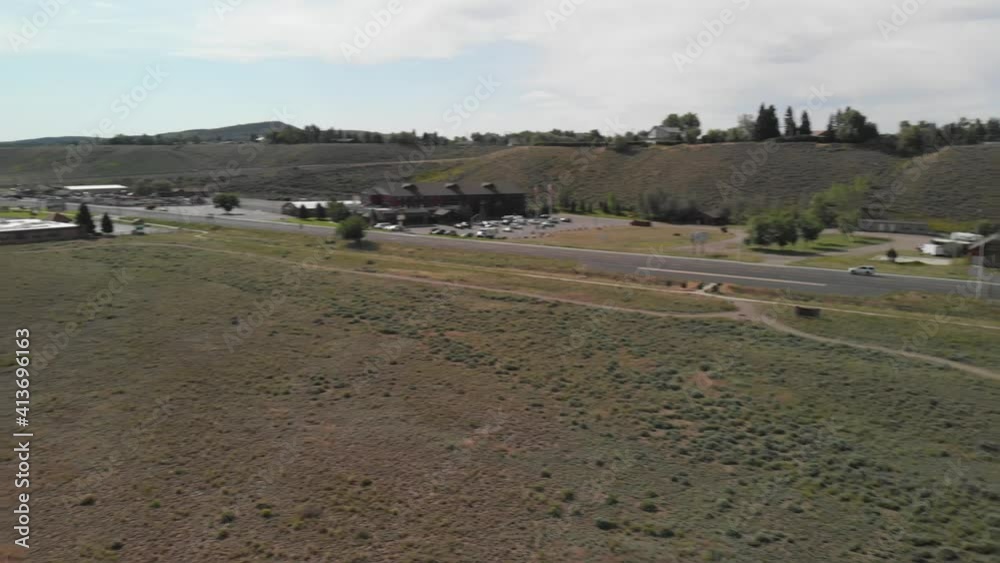 Fast aerial ninety degree aerial pan near the Cody Night Rodeo Park in northern Wyoming during the summer. Fast aerial ninety degree aerial pan near the Cody Night Rodeo Park in northern Wyoming during the summer.