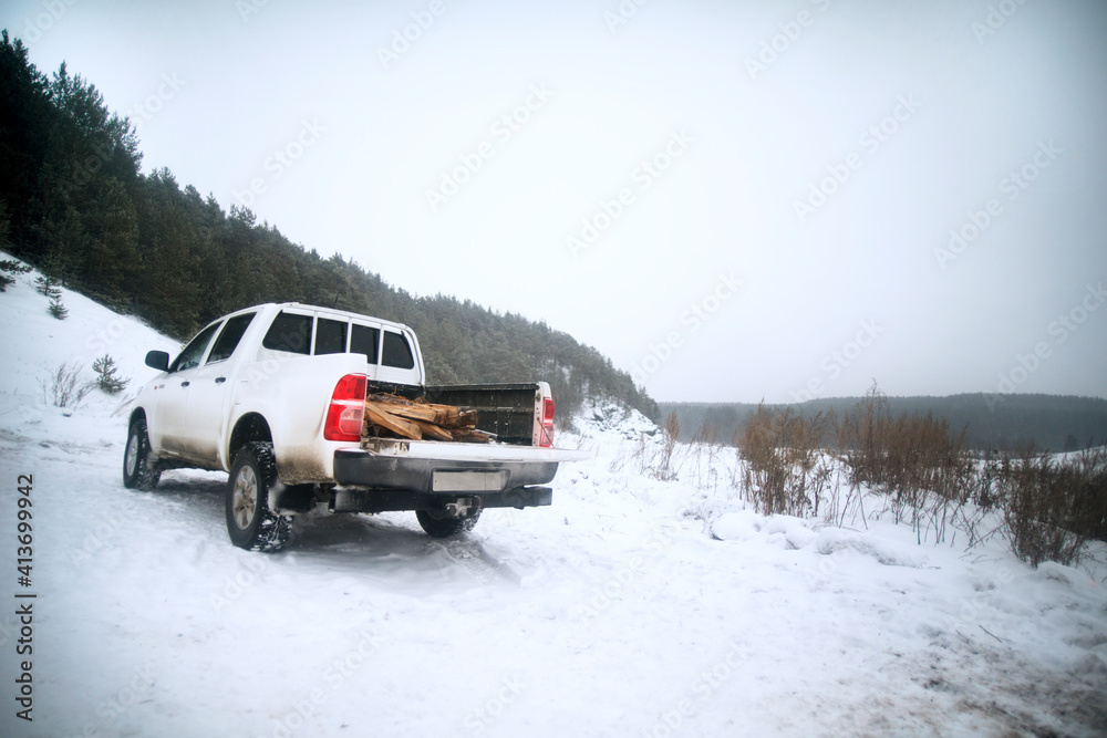 Off-road vehicle parked on snow covered field against sky Off-road vehicle parked on snow covered field against sky