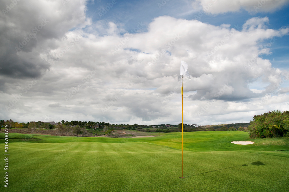 Scenic view of golf course against cloudy sky Scenic view of golf course against cloudy sky