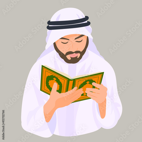 Muslim man praying with the holy koran in his hands 