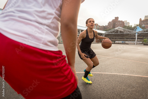 Basketball players playing in court